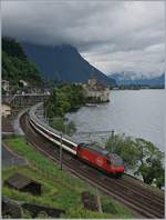 A SBB Re 460 with an IR to Geneva near the Castle of Chillon.