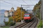 A SBB Re 460 with an IR 90 by the Castle of Chillon.