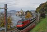 A SBB Re 460 with an IR90 on the way to Geneva by the Castle of Chillon.