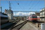 The SBB Re 460 094-6  Mobility  with an IR is arriving at Lausanne.