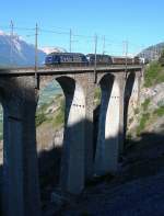 Two BLS Re 465 with a RoLa train on the Lugelkinn-Bridges.
