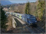 The BLS Re 465 003-2 wtih an RE on the way to La Chaux de Fonds near Chambrelien.