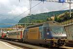 On 25 May 2004 BLS 465 008 advertises the Golden Pass Panoramic Express while standing at Spiez with a north bound intermodal service from Italy.