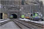 The BLS Re 465 002 (not to see) and the BLS R 465 017 with his AT1 to Kandersteg are entering in the Lötschberg-Tunnel in Goppenstein. On the left a BLS Tm 232. 

03.01.2024t 