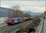 Re 482 000-7 is hauling a goods train through Oberwesel on March 19th, 2010.