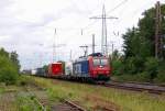 The swiss cargo railway class 482 004-0 rides through the former station Lintorf southwards with an containertrain.