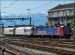 The SBB Cargo Re 620 042-2 is hauling two goods wagons through the station of Lausanne on May 29th, 2012.