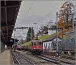 The SBB Re 6/6 11631 is leaving La Chaux de Fond in the direction of Le Locle.