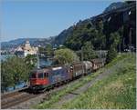 The SBB Re 620 075-2 with a Cargo train by Villeneuve with the Castle of Chillon in the background.