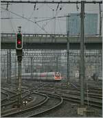 In diffuse morning light, an SBB ICN arrives at Zurich main station.