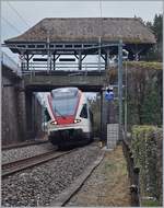 The SBB RABe 535 015 to Vallorbe by the Castle of Chillon.