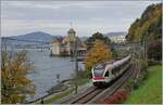 The SBB 523 013 on the way to Allaman an a stemaer in the background by the Castle of Chillon.