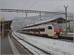 In gloomy winter weather, SBB RABe 523 111 (and another) are traveling as a regional train to Aigle.