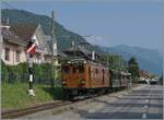 The Bernina Railway RhB Ge 4/4 81 reaches Blonay with its train and passes by the Hipps turntable.