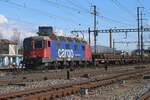 SBB Cargo 620 074 hauls a maintenance train through Pratteln on 13 February 2024 and gets photographed from a well-known vantage point.