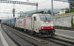 On a soaking wet 14 May 2010 CrossRail 185 580 hauls an intermodal service through Spiez toward Basel.