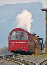 . A BRB train is leaving the summit station Rothorn Kulm on September 28th, 2013.