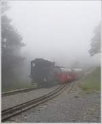 . A BRB train is leaving the halfway passing loop Planalp on the foggy September 29th, 2013.