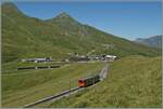 A small train in a magnificent mountain landscape: A Jungfrau Railway (JB) BDeh 4/4 with Bt has left Kleine Scheidegg, visible in the background, and is now on its way to the highest railway station