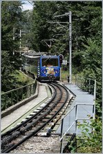 The Rochers de Naye Beh 4/8 302 and an other one are arriving at Le Tremblex.