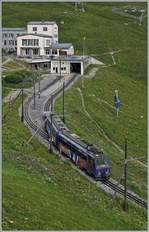 The Rochers de Naye Bhe 4/8 303 is arriving at the summit Station.