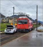 The locomotive in the foreground is called HGem 2/2 2501; and the car in the middle of the tracks in Blonay station takes note of the  m  in the locomotive name: The locomotive is being refueled! March 1, 2024