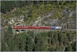 A RhB Ge 4/4  III 649  20 Minuten  with his Albula Fast-Serice from Chur to St Moritz by the Landwasser Viaduct near Filisur.