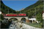 The RhB Ge 4/4 II 631 coming with his local train from Scuol is crossing the River Susasca in Susch.