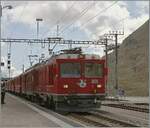 The RhB Gem 4/4 801 and a RhB ABe 4/4 II with a Bernina local service on the way to St Moritz by his stop in Ospizio Bernina.