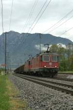 Two SBB Re 4/4 II with a long cargo train by Felsberg...