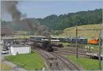 With a steam train of the 'Emmentalbahn,' the E 3/3 853 (UIC 90 85 0008 573-3) leaves the station of Sumiswald-Grünen heading towards Wasen in the Emmental. In the background, the ABe 4/4 No. 12 with the Bodan salon car and the VH-MThB BDt can b ...