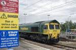 Ely, Freightliner 66516 with container, entering Ely Station from the north, warning signs.