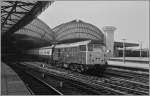 A British Rail (BR) Class 31 diesel locomotive with his train is leaving York Station.