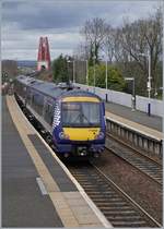 The Scotrail 170 454 in Dalmeny; in the background the Forth Bridge.