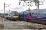 northbound National Express 170 270 passing First Capital Connect to London at levelcrossing north of Ely Station.