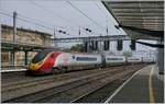 he Virgin Pendolino 390 122 on the way to London Euston is leaving Carlisle.