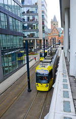 Tram 3019 (left) passing Tram 3110 (right) on the line between Piccadilly Gardens and Piccadilly Station.