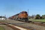 Three engines of the type Dash 9 with a long freight train (113 cars!) in Sealy (Texas).