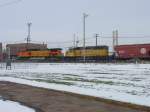 BNSF 5370 & Canadian Pacific 5424 pull a mixed freight thru the Burlington, Iowa yard and are about to cross Main Street.