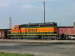 BNSF 7801 is coupled to (former Santa Fe) BNSF 6335 on the front and a gondola full of scrap steel pulled from a West Burlington, Iowa scrap yard on 11 June 2005.