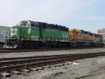 An old Burlington Northern unit 1507 remarked with BNSF lettering on the cab sits with a BNSF Heritage I paint scheme lok 2130 and a Santa Fe unit ? 2475 ? with the beginning of a freight train that