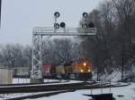 BNSF 5370 and Canadian Pacific 5424 pull a mixed freight around the curve after just crossing the Mississippi River.