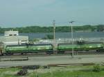 A pair of Burlington Northern tank cars rolls thru the Burlington, Iowa yard on 26 July 2003.