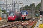 Alstom ntv 22 Italo, enters into Ferrara station, the ETR 104 train is shunting on the intermediate track. May 8th, 2025.