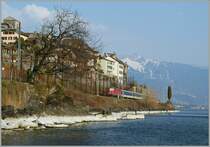 A SBB Re 4/4 II with a  Dispotrain  on the way to Vevey by St Saphorin.
25.03.2012