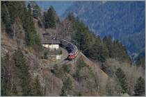 A SBB Re 4/4 II with an IR Locarno to Basel near Wassen. 14.03.2014