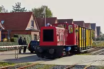 . The narrow gauge Diesel engine  M�nster  is hauling the heritage waggon N� 48 on the track of the Borkumer Kleinbahn on October 8th, 2014.