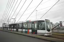 RET 2112 on Line 20 from Rotterdam Centraal to Kreekhuizenlann on the Erasmusbridge. The Tram is a model Citadis. Date: 7. October 2011. The bridge is not equal - that's why the tram is going a bit uphill on the photo.