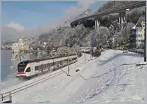The SBB Flirt RABe 523 031 on the way to Vallorbe by the Castle of Chillon.

29.01.2019