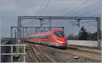The FS Trenitalia ETR 400 010 is the  Frecciarossa 1000  FR 9624 on the way from Roma Termini to Milano Centrale and runs wiht a very hight speed trough the Reggio Emilias AV Station. 

14.03.2023